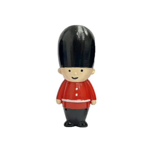 Front view of a Guardsman stretchy fidget toy, featuring a black bearskin hat, a smiling face, a red jacket with white trim and buttons, and black trousers, against a white background.