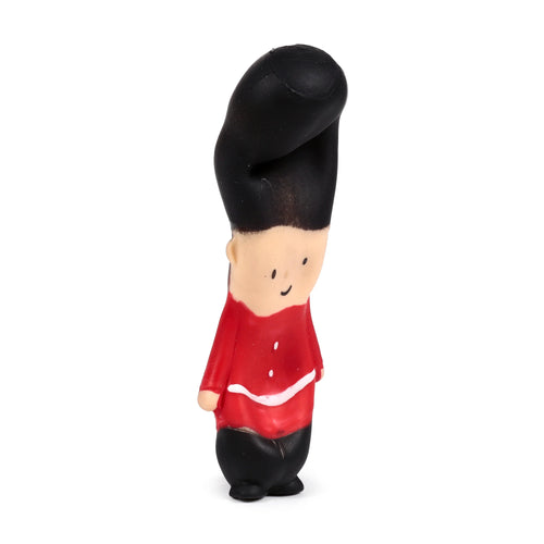 Angled view of a Guardsman fidget toy, featuring a black bearskin hat, red tunic with white trim, black trousers, and a smiling face.