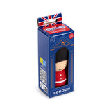 Angled view of a Guardsman stretchy fidget toy in blue packaging, featuring a Union Jack flag on the hanger. The box displays the Guardsman figure, visible through a window, wearing a black hat and red uniform, with 'LONDON' text printed below.