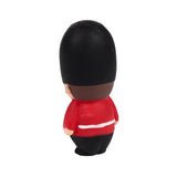 Angled back view of a stretchy Guardsman fidget toy, featuring a black bearskin hat, red tunic with a white band, and black trousers.