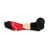 Lying horizontally, a stretchy Guardsman stress fidget toy with a black bearskin hat, red uniform, and a light-toned face featuring simple black eyes and mouth, displayed against a white background.