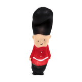 Front view of a stretchy Guardsman fidget toy, featuring a peach-coloured face with a smile, black bearskin hat, and a red uniform with white buttons and belt detail.
