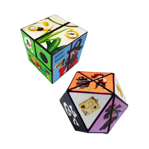 Angled view of two multi-coloured pirate-themed puzzle cubes, displaying illustrations including a pirate with a spyglass, a treasure map, 'Ahoy Matey' text, and a skull and crossbones.