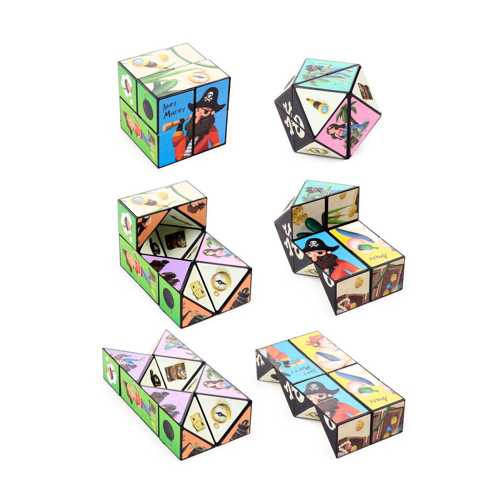 Multiple views of a colourful pirate-themed puzzle cube toy, presented in various configurations, featuring illustrations of cartoon pirates, treasure maps, compasses, and other Jolly Rogers motifs.