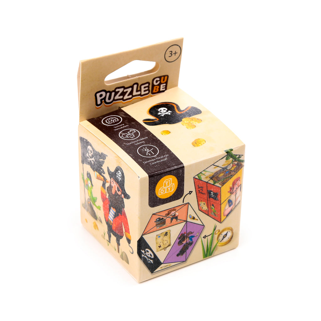 Angled view of a Jolly Rogers Pirate Puzzle Cube toy in its retail packaging. The cardboard box features colourful illustrations including a buccaneer, a parrot, gold coins, and a skull and crossbones emblem. The text 'PUZZLE CUBE' and age rating '3+' are visible, alongside a graphic showing the assembled pirate-themed cube.