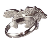 Close-up angled view of a silver-coloured mood ring, showing the textured underside of its decorative top and the adjustable band.
