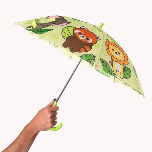 Kids' umbrella, held open, depicting a light green canopy with cartoon wild animals, including a red panda and lion, plus paw prints and green leaves. A hand holds the bright green curved handle.