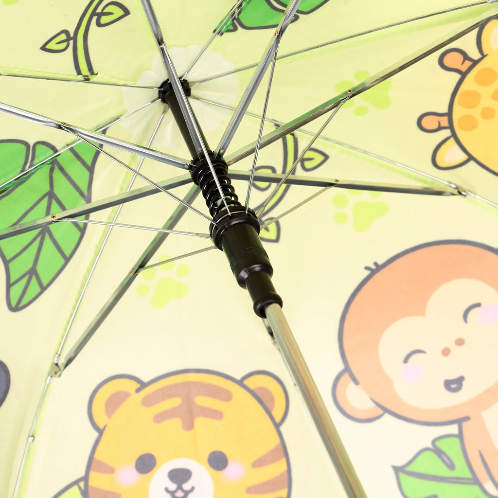 Inside view of a kids' umbrella, showing a light yellow canopy patterned with cartoon monkey, tiger, and giraffe faces, green leaves, and paw prints. The black central mechanism and silver metal ribs are clearly visible.