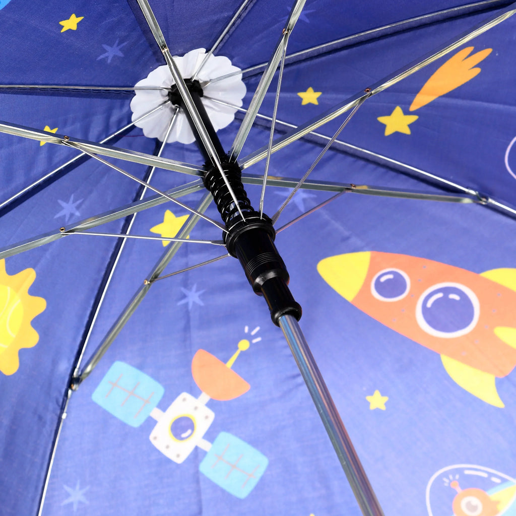 Underside view of a blue kids' umbrella canopy with space-themed illustrations including rockets, stars, and satellites, revealing the silver ribs and black central mechanism.