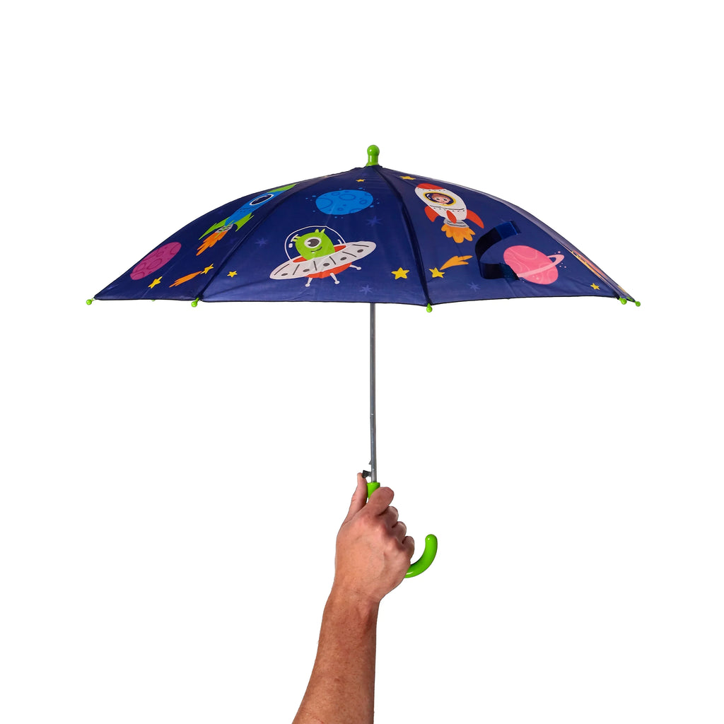 Kids' dark blue umbrella featuring a space cadet, rockets, planets, and stars design, held open by a hand, revealing its bright green handle and finial.