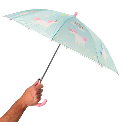 Open light blue kids' umbrella held by a hand, featuring a unicorn, rainbow, and star pattern, with a pink hooked handle and matching rib tips.