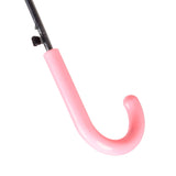 Close-up of a kids' umbrella handle, showing its curved shape and light pink colour, with part of the black shaft visible above.