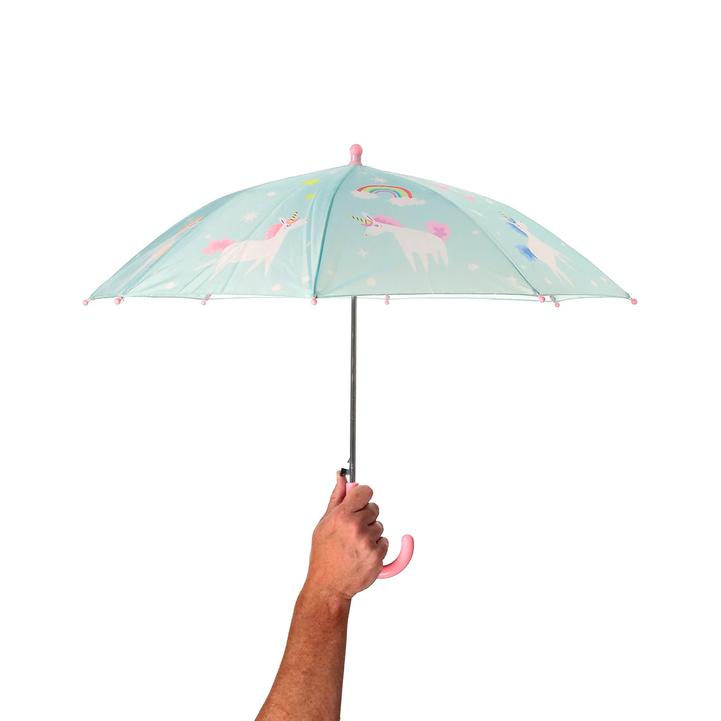 Kids' light blue umbrella with unicorn, rainbow, and star patterns, held open by a hand, revealing the pink hook handle and matching finial.
