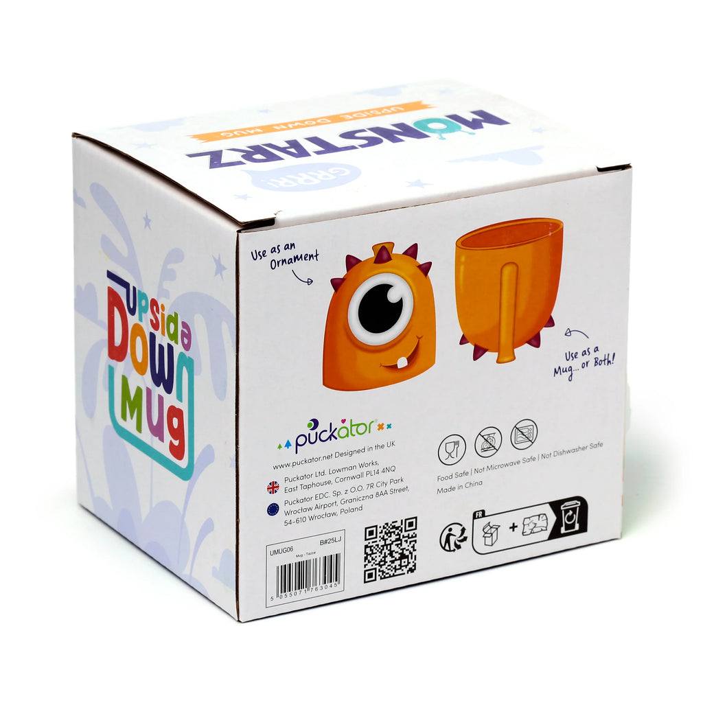 Angled view of the white product packaging for a Monstarz Monster Orange Upside Down Ceramic Shaped Mug, featuring colourful 'Monstarz' branding, an illustration of an orange one-eyed monster mug, and text indicating Use as an Ornament and Use as a Mug... or Both!. The box also displays 'Food Safe', 'Not Microwave Safe', and 'Not Dishwasher Safe' icons.