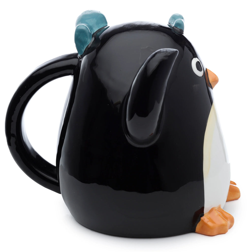 Angled view of a glossy black and white ceramic penguin upside down mug, with orange beak and feet, blue head details, and a black handle.
