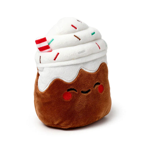 Front view of a plush brown microwavable heat pack designed as a spiced latte. It features a smiling face with red cheeks, white whipped cream with colourful embroidered sprinkles, and a red and white striped stick on top.