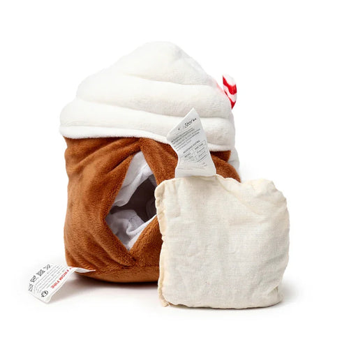 Angled view of a brown and white plush microwavable wheat pack, designed as a spiced latte with a small red and white striped accent, its removable light-coloured wheat pack insert shown alongside its side opening.
