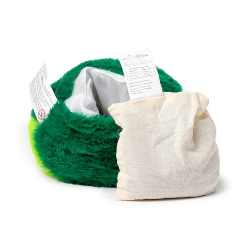 Angled view of a green plush microwavable heat pack, open to reveal its white interior, with a cream-coloured removable wheat bag insert placed beside it.