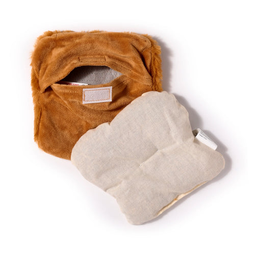 Angled overhead view of a brown plush heat pack cover, shaped like a slice of toast, with its cream fabric inner pouch partially removed.