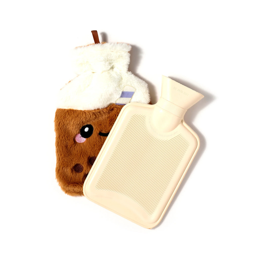 Overhead view of a cream hot water bottle with ribbed texture, partially removed from its brown, fluffy plush cover designed as a bubble tea cup with an embroidered face and white 'whipped cream' top.
