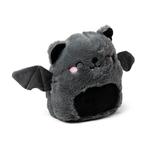 Front view of a dark grey microwavable plush bat heat pack, with black ears, small wings, and a recessed black belly. The bat features embroidered black eyes, nose, mouth, white fangs, and pink cheeks.