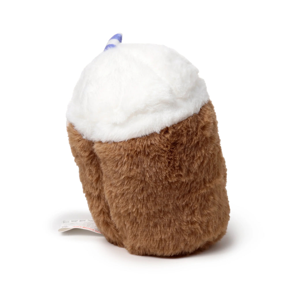 Angled view of a plush bubble tea heat pack with a brown base, white top, and a blue and white striped straw.