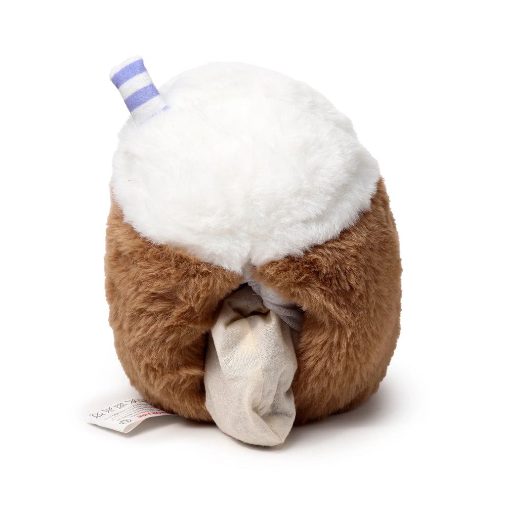 Angled view of a fluffy brown and white bubble tea plush heat pack, showing a purple and white striped straw, the cream-coloured removable inner pouch, and a care label.