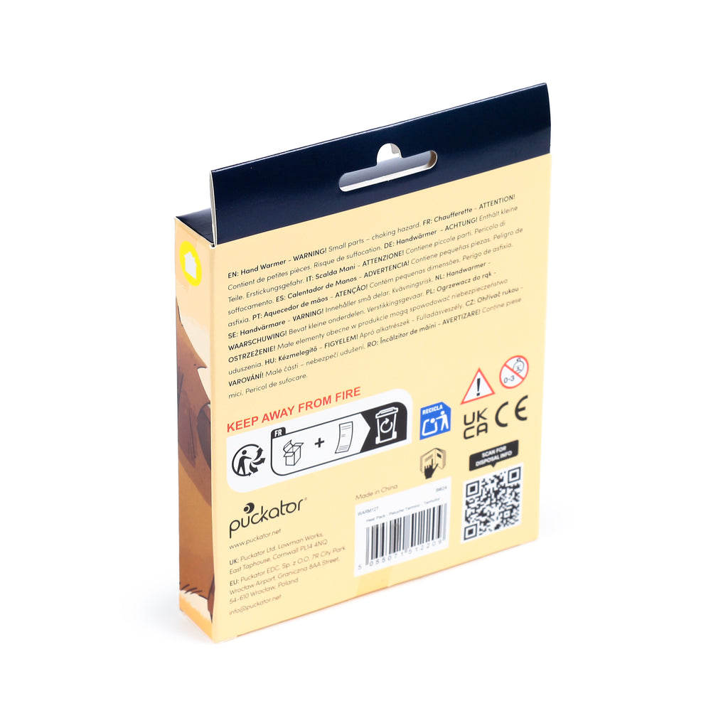 Angled view of beige and dark blue hand warmer packaging, displaying a hanger tab, warning labels, recycling symbols, a barcode, and multi-language text.