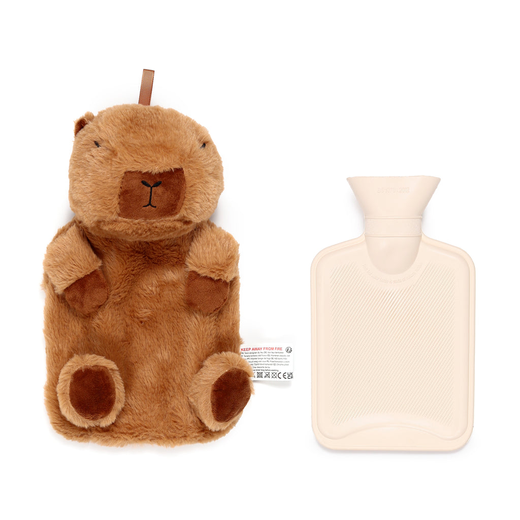 Overhead view of a brown plush capybara hot water bottle cover, featuring embroidered eyes and nose, displayed next to a plain cream-coloured rubber hot water bottle with a ribbed texture.
