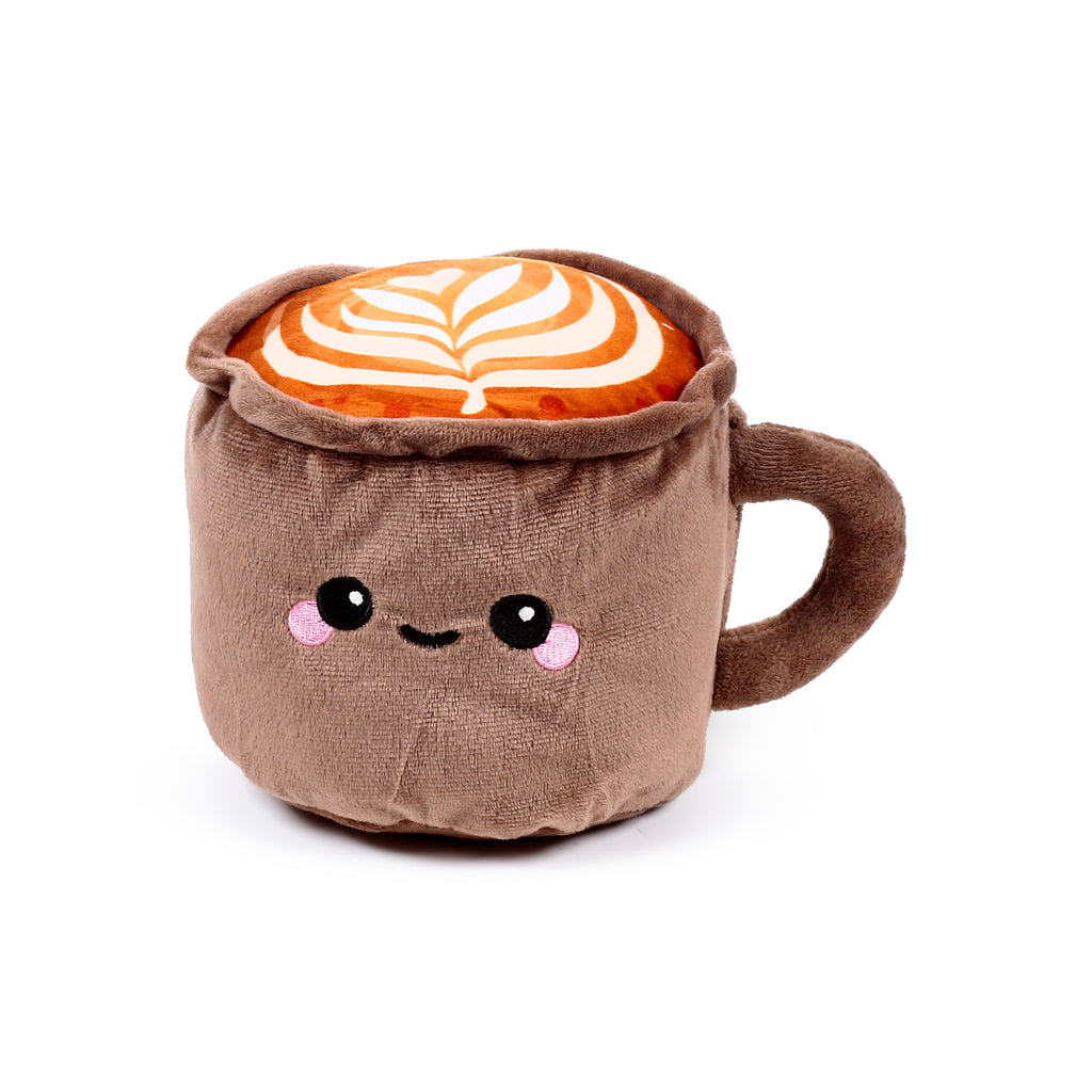 Angled front view of a brown plush cappuccino mug heat pack with an embroidered cute face and white latte art on its orange top.
