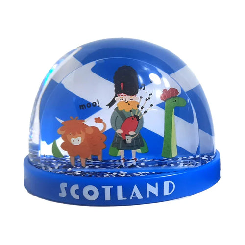 Front view of a Scotland-themed snow globe, featuring cartoon figures of a Highland cow, a bagpiper, and the Loch Ness Monster against a Scottish flag background. The blue base is embossed with 'SCOTLAND' and contains blue glitter.