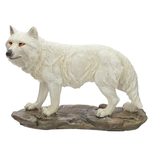 Angled view of a white wolf figurine, featuring textured fur details and vivid amber eyes, posed on a naturalistic rocky base.