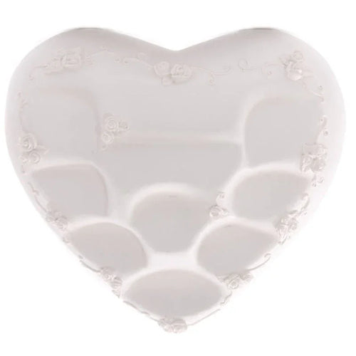 Overhead view of a white heart-shaped display stand featuring multiple internal compartments and embossed rose and vine embellishments along its edges.
