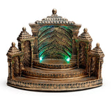Front view of an ornate antique gold LED display stand, featuring a temple-like structure with tiered steps and green lights illuminating the recessed base.