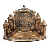Front view of an ornate antique bronze display stand with a tiered platform, featuring intricate temple-style carvings, decorative pillars, and a textured back wall, on a white background.