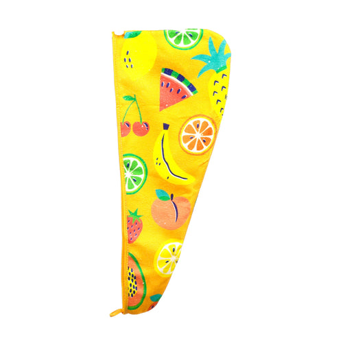 Angled view of a yellow hair wrap towel featuring a colourful summer fruits pattern, including cherries, bananas, orange slices, watermelon, pineapple, lemons, limes, peaches, strawberries, and papayas.