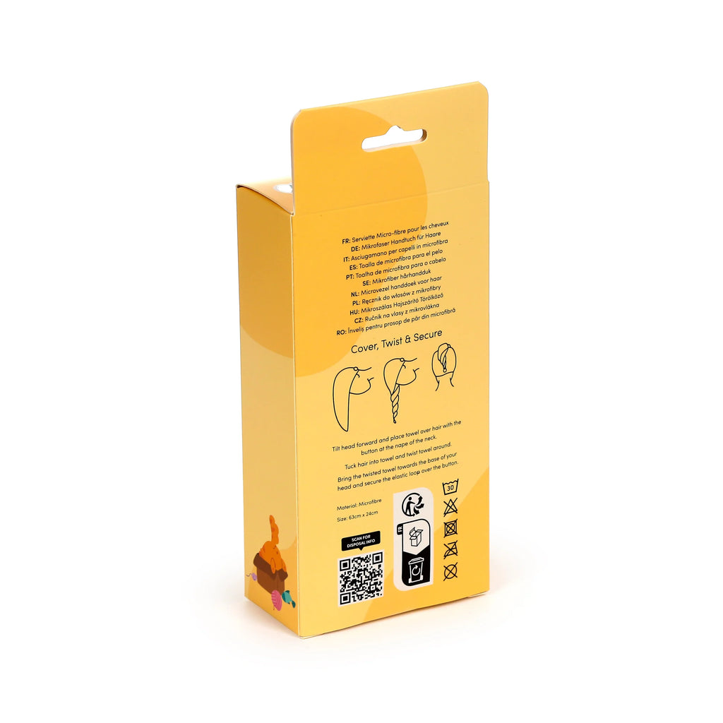 Angled view of yellow hair wrap towel packaging, showing multi-language product descriptions, illustrated usage instructions, microfibre material details, dimensions 63cm x 24cm, and laundry care symbols.