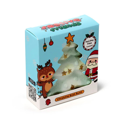 Front-angled view of a Christmas tree shaped bath bomb in a light blue gift box. The green and white bath bomb, adorned with golden stars, is visible through the box's tree-shaped window. The festive gift box is decorated with Christmas character illustrations and explicitly labeled 'Christmas Bath Bomb' and 'Holiday Pine Scented'.