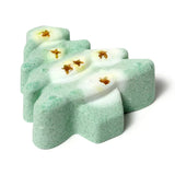 Angled view of a green and white Christmas tree shaped bath bomb with gold star details.