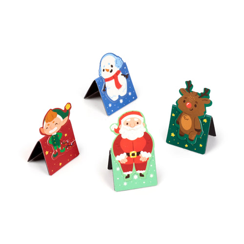 Angled view of four Christmas character magnetic bookmarks, including an elf, snowman, Santa Claus, and a reindeer, standing upright on a white background.
