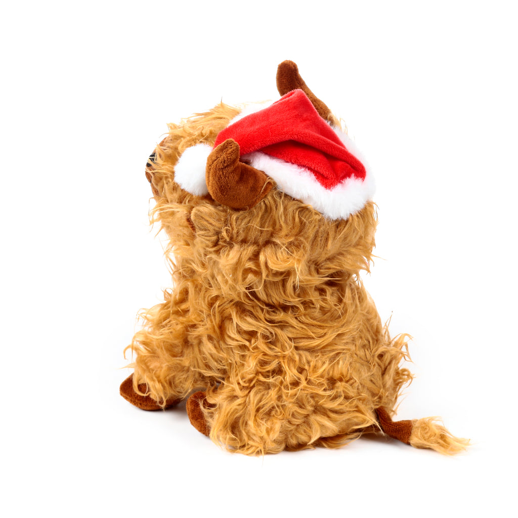 Angled view of a plush Christmas Highland Coo door stop, seated, displaying shaggy brown fur, small brown horns, and a red Santa hat with white trim.
