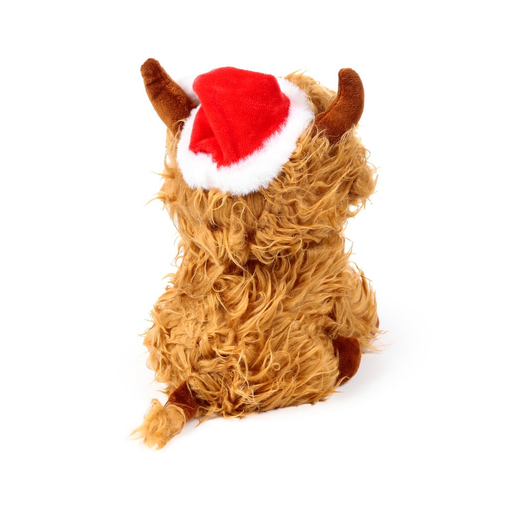 Angled rear view of a Christmas Highland Coo plush door stop, featuring shaggy light brown fur, small brown horns, and a red and white Santa hat.
