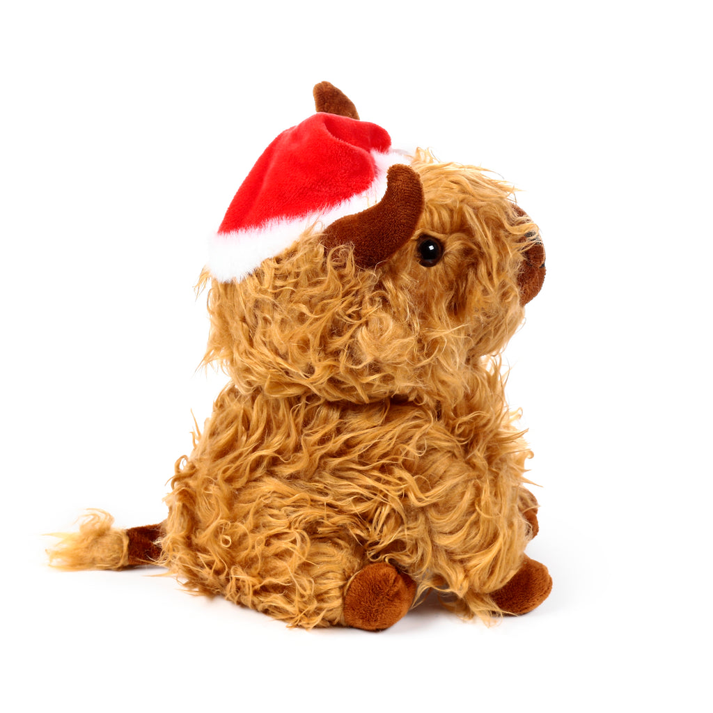 Angled view of a plush Christmas Highland Coo door stop, with shaggy light brown fur, dark brown horns, and a red Santa hat.