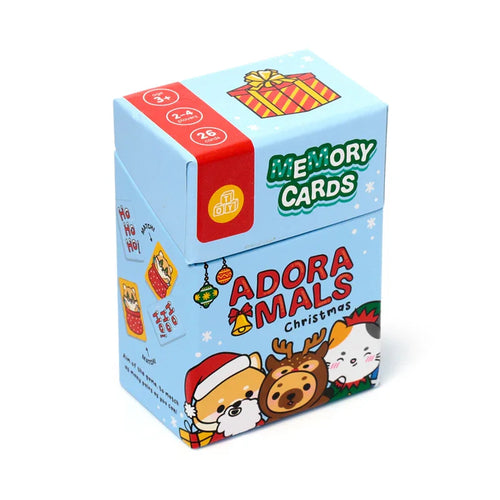 Angled view of a light blue kids' 'Adoramals Christmas' memory card set box, featuring festive animal characters, 'Memory Cards' title, and game details on the packaging.