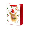 Front view of a large white Christmas gift bag with red sides and red ribbon handles, featuring a watercolour illustration of a Highland coo wearing a red Santa hat, surrounded by green holly leaves and red berries.