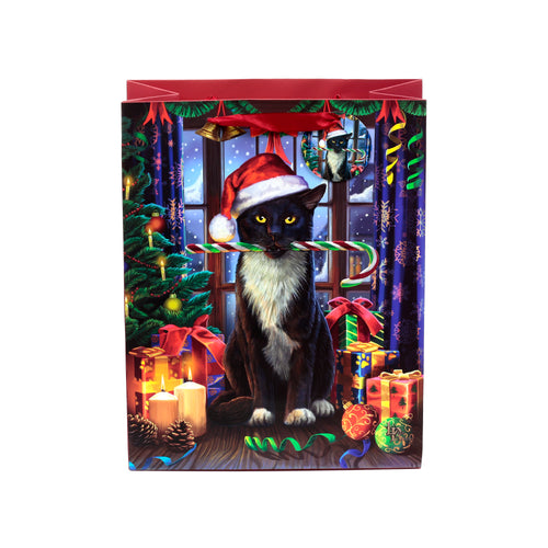 Front view of a Christmas gift bag featuring a black cat in a red Santa hat holding a red and green candy cane. The festive illustration includes a decorated Christmas tree, wrapped presents, and lit candles, with a snowy window backdrop. A smaller circular image depicts another black cat in a Santa hat, and the bag has a red top border.