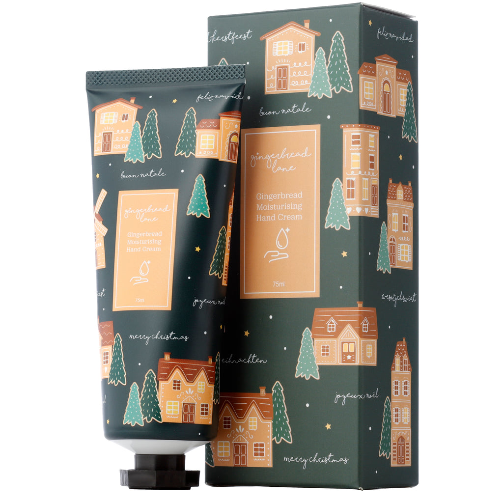 Angled front view of a dark green 75ml Moisturising Hand Cream tube and matching rectangular gift box, both featuring a festive Christmas gingerbread lane design with brown and orange gingerbread houses, green Christmas trees, and small yellow stars, clearly displaying the 'Gingerbread Moisturising Hand Cream 75ml' label.