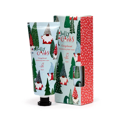 An angled view of a 75ml gingerbread moisturising hand cream tube and its coordinating gift box. Both feature a light blue background adorned with Christmas gonk figures and green fir trees. The visible side of the box displays a red and white polka dot pattern.