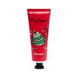 Front view of a red moisturising hand cream tube, adorned with a Christmas Pusheen the Cat illustration, depicting a grey cat dressed as a festive Christmas tree with a yellow star, surrounded by baubles, bells, and stars.