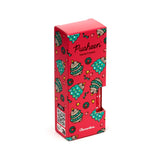 Angled view of a red Christmas-themed hand cream box, decorated with green Christmas trees, wreaths, bells, and illustrations of Pusheen the cat. The front displays 'Pusheen Hand Cream' and 'Clementine' text, with a red tube visible through a side cut-out.
